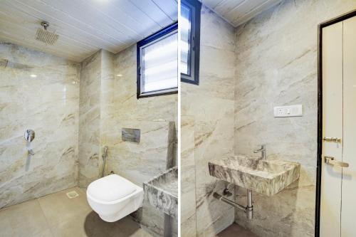 a bathroom with a toilet and a sink at Super Collection O Sanpada Railway Junction in Turambhe