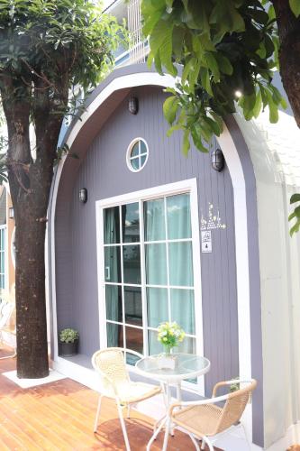 a purple house with a table and chairs at Grace Riverfront in Lat Krabang