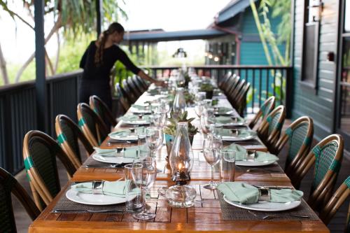 a dining room table set with chairs and tables at Lumeria Maui, Educational Retreat Center in Makawao