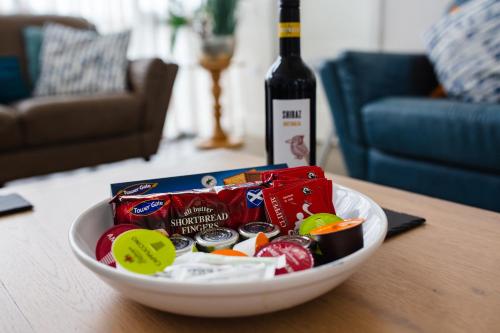 a bowl of candy and a bottle of wine on a table at Betony in Bamburgh