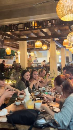 a group of people sitting at a table eating at Daffodil Restaurant & Holiday Resort in Unawatuna