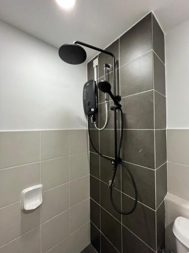 a shower with a shower head in a bathroom at Landed KLIA Netflix, Fully AC&Heater, Kids Pool in Sepang