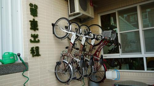 a group of bikes hanging on a wall at 台東愛格斯 單車友善&溯溪&包車旅行 EGGS Bike & River tracing & Chartered car tour in Taitung City