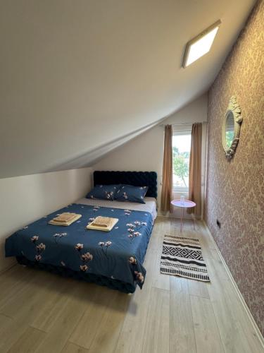 a bedroom with a blue bed and a window at Dunavska lepotica 2 in Belgrade