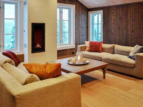 a living room with two couches and a coffee table at 12 person holiday home in Fåvang in Favang