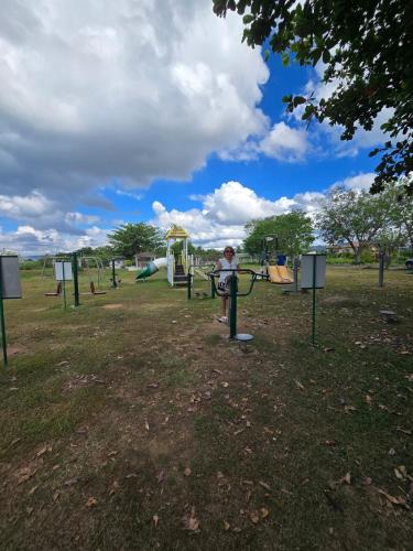 a person standing in a park with a playground at Beautiful four bedroom home in Talisay