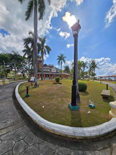 a street light in a park with palm trees at Beautiful four bedroom home in Talisay