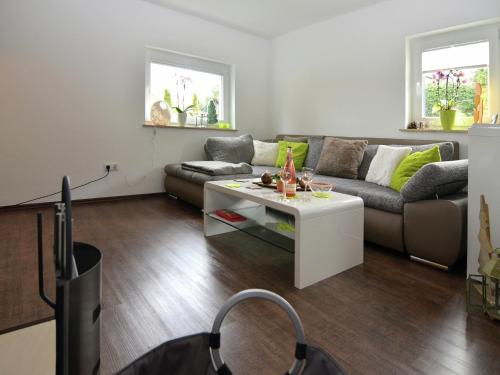 a living room with a couch and a coffee table at Ferienhaus in Schwarzhausen in Schwarzhausen