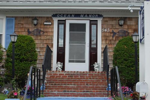 a front door of a house with a sign that reads ocean manor at A Cape Cod Ocean Manor Inn in Hyannis