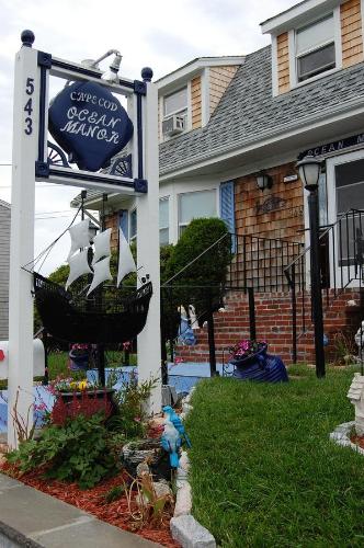 a sign for a coffee shop in front of a house at A Cape Cod Ocean Manor Inn in Hyannis