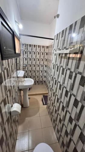 a bathroom with a toilet and a sink at Résidence Agbevivi in Aného