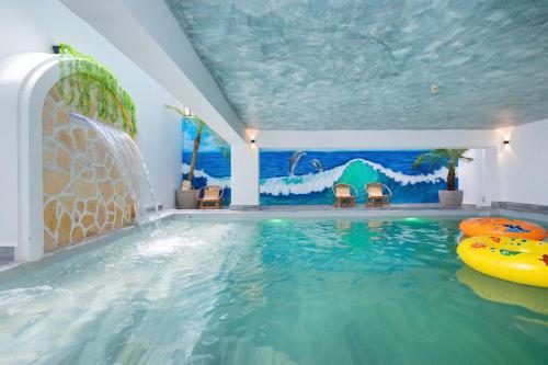 a indoor swimming pool with a wave painted on the ceiling at Villa Hồ Bơi Bida Karaoke Sân Nướng BBQ in Vung Tau