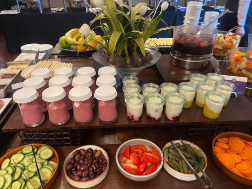 a table filled with different types of fruit and drinks at L'Heritage Riverside Hoi An in Hoi An
