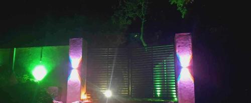 a green traffic light and a building at night at Euro Elephant Yala in Tissamaharama