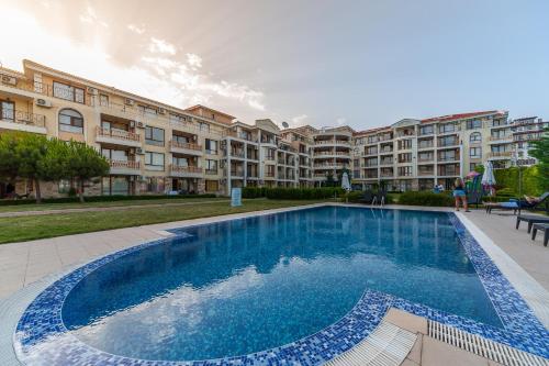 a large swimming pool in front of a building at MAISONETTES in Royal Bay Residence and SPA in Sveti Vlas