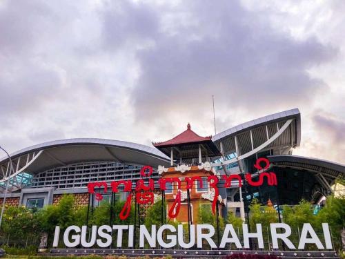 a building with a sign in front of it at RBE Hotel Kuta 2- 5 Min to Airport&Beach by Micky Studio in Ngurah Rai International Airport