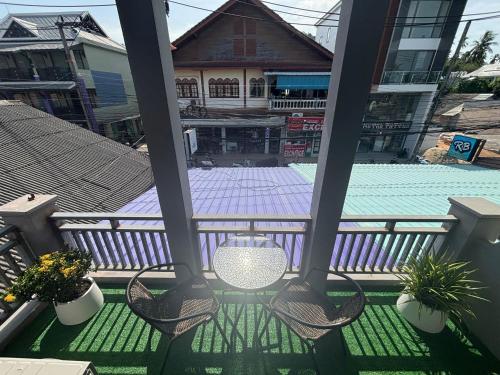 a balcony with chairs and a swimming pool at Lamai Beachroad Apartment in Amphoe Koh Samui