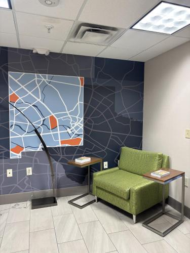 a waiting room with a green couch and a wall at Holiday Inn Express & Suites Truth Or Consequences by IHG in Truth or Consequences