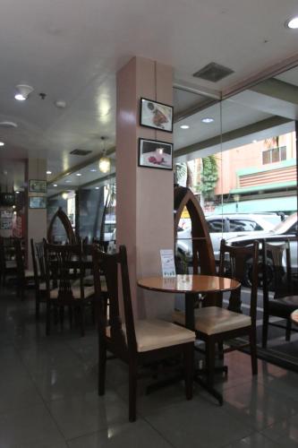 a dining room with tables and chairs in a restaurant at Harbor Town Hotel in Iloilo City