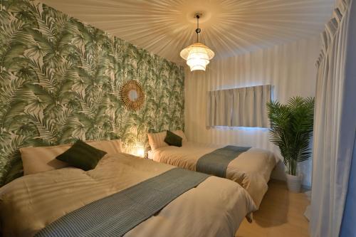 Giường trong phòng chung tại Otter Stay - Masaki