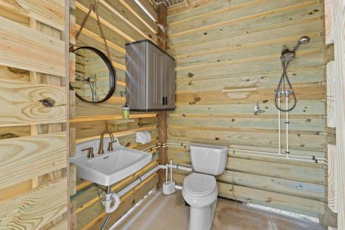 a bathroom with a sink and a toilet and a tv at The Sea Salt Sandcastle in St. George Island