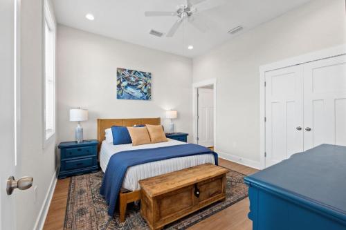 a bedroom with a bed and a blue dresser at The Sea Salt Sandcastle in St. George Island
