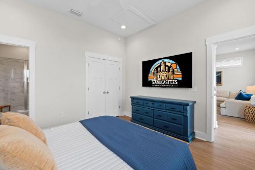 a bedroom with a bed with a blue dresser at The Sea Salt Sandcastle in St. George Island