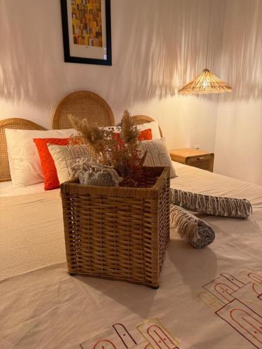 a bedroom with a bed with a basket on the floor at Villa Ghalya in Al Maqārisah