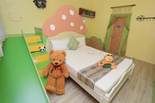 a bedroom with a teddy bear and a bed with a mushroom at Sweetheart Homestay in Luodong