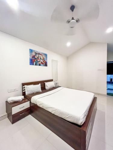 a bedroom with a large bed and a ceiling at Swarg Resort in Pune
