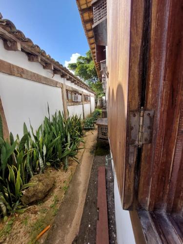 an open door of a building with plants on the side at Pousada dos Veleiros in Nova Almeida