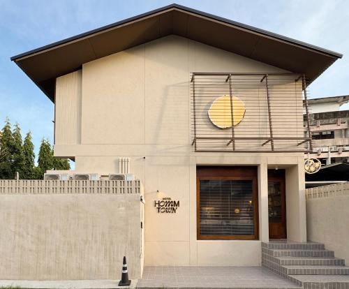 a building with a sign on the side of it at hotel hommtown chiang mai in Chiang Mai