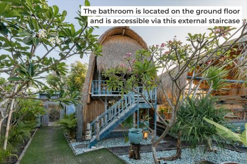 a garden with a building with a stairway in it at Laguna Biru in Nusa Lembongan