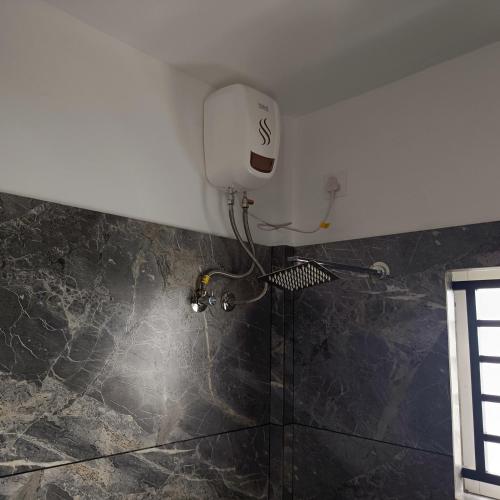a shower in the corner of a bathroom at Hotel Eleven Space Kochi in Cochin