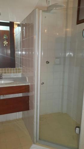 a bathroom with a shower and a sink at Pousada dos Veleiros in Nova Almeida