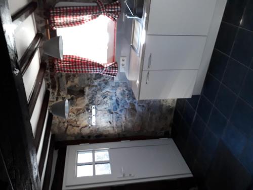 an overhead view of a bathroom with a window at Nice gite with low ceilings in Han-sur-Lesse in Han-sur-Lesse