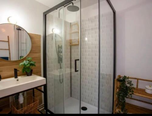 a glass shower in a bathroom with a sink at Au Calme VUE MER in Saint-Brévin-lʼOcéan