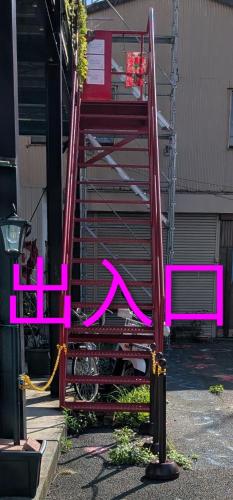 a pink fence with a bench in front of a building at いちごの里祭り村 in Shizuoka