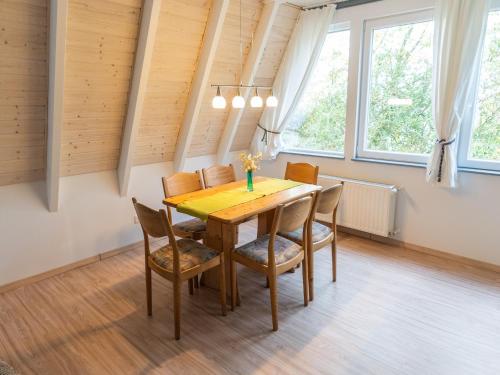 a dining room with a wooden table and chairs at Ferienhaus in Bestwig mit privatem Garten in Bestwig