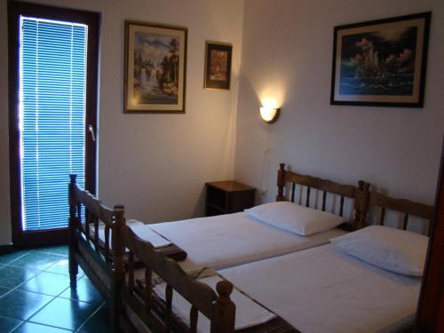 a bedroom with two beds and a window at Apartments Svorcan in Budva