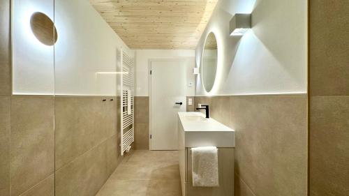 a bathroom with a sink and a mirror at See I Jacuzzi I Balkon I Parkplatz I Bio Hof I TV in Rieden am Forggensee