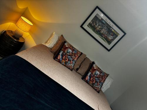 a bedroom with a bed with two pillows on it at Modern Beach Apartment with Pool & Location in Mount Maunganui