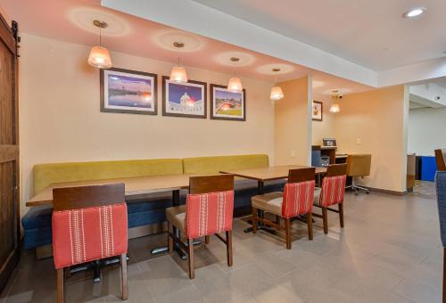 a dining room with a table and chairs at Comfort Inn & Suites Montgomery East Carmichael Rd in Montgomery