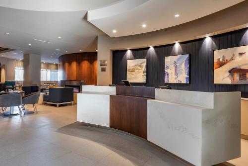 a lobby of a hotel with a reception desk at Cambria Hotel Minneapolis Downtown in Minneapolis