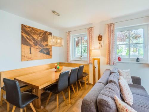 a kitchen and dining room with a table and a couch at Chalet in Niedernsill near Ski Slopes in Niedernsill