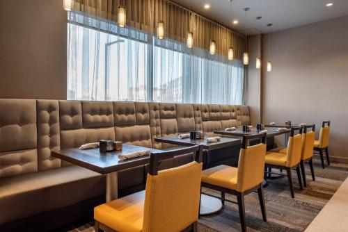 a row of tables and chairs in a restaurant at Cambria Hotel Minneapolis Downtown in Minneapolis