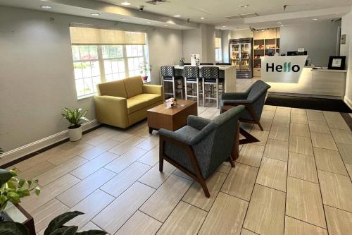 a waiting room with chairs and a table in a store at MainStay Suites Sterling near Dulles Town Center in Sterling