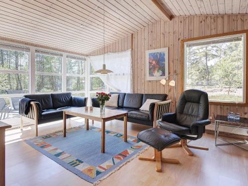 a living room with a couch and a table at 4 person holiday home in Nexø in Neksø