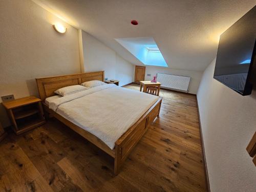 a bedroom with a large bed and a tv at Casa Miorita in Cumpăna