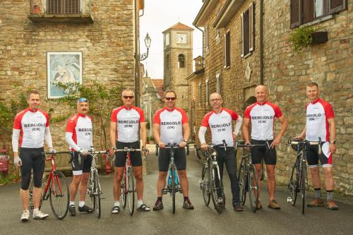 a group of men standing in a street with their bikes at Albergo Ristorante 'l Bunet in Cortemilia